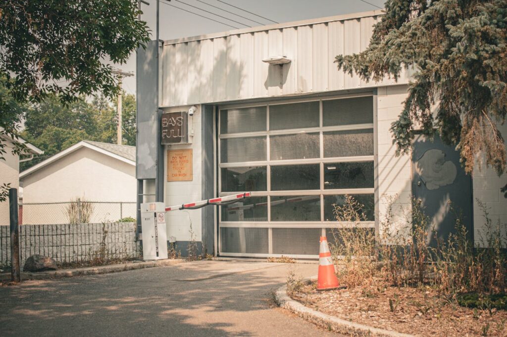 A parking garage entrance with a 'Full' sign and barricade, surrounded by trees.